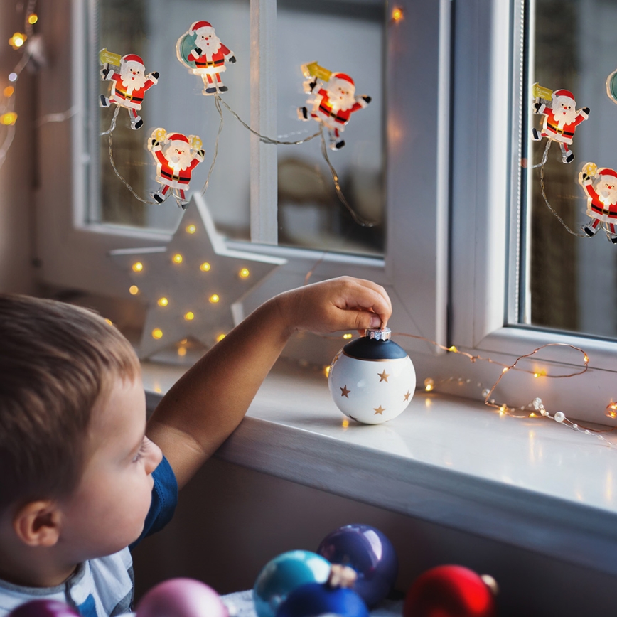 LED jouluketju imukupeilla 6xLED/2xAA 1,2m lämmin valkoinen joulupukki