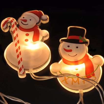 LED jouluketju imukupeilla 6xLED/2xAA 1,2m lämmin valkoinen lumiukko